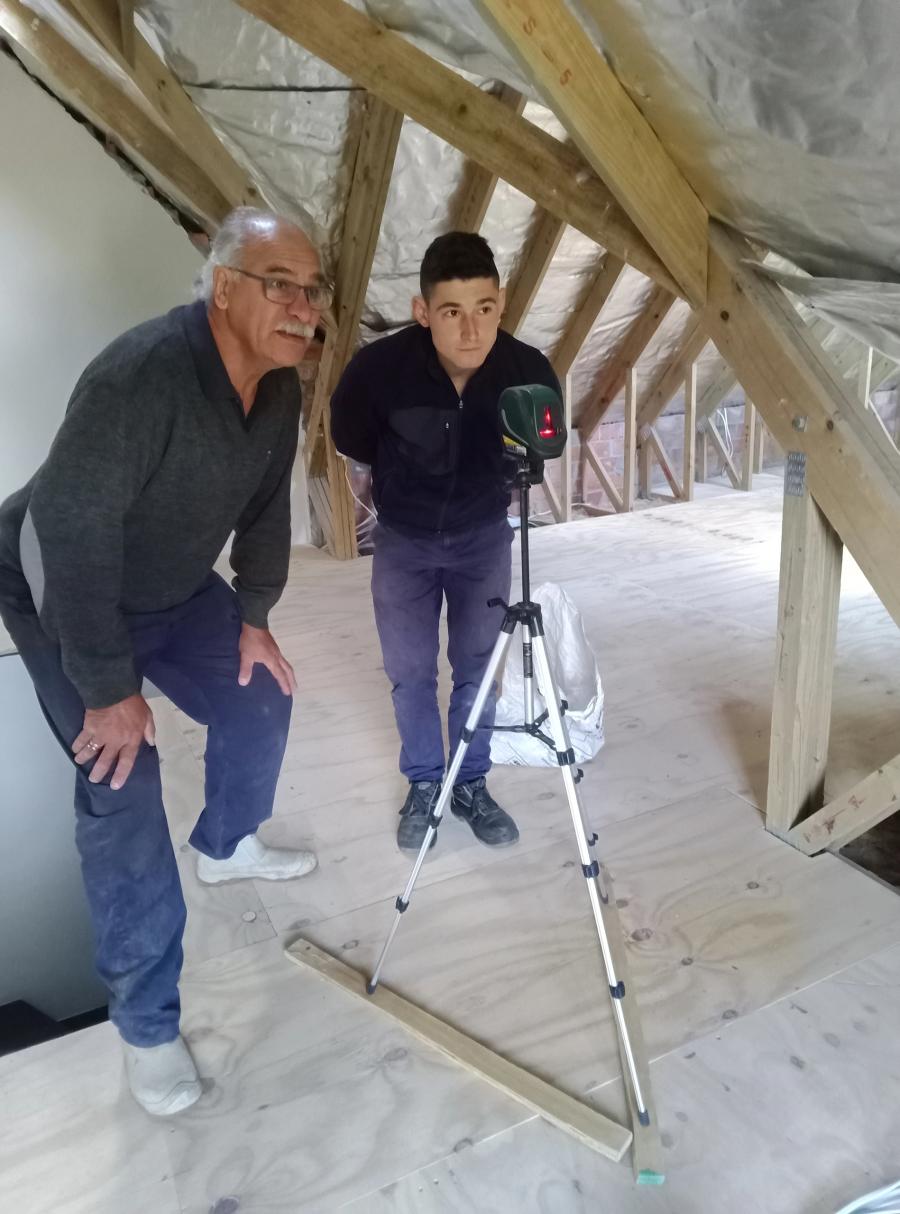Bulldog Plumbing setting out an installation with a laser level