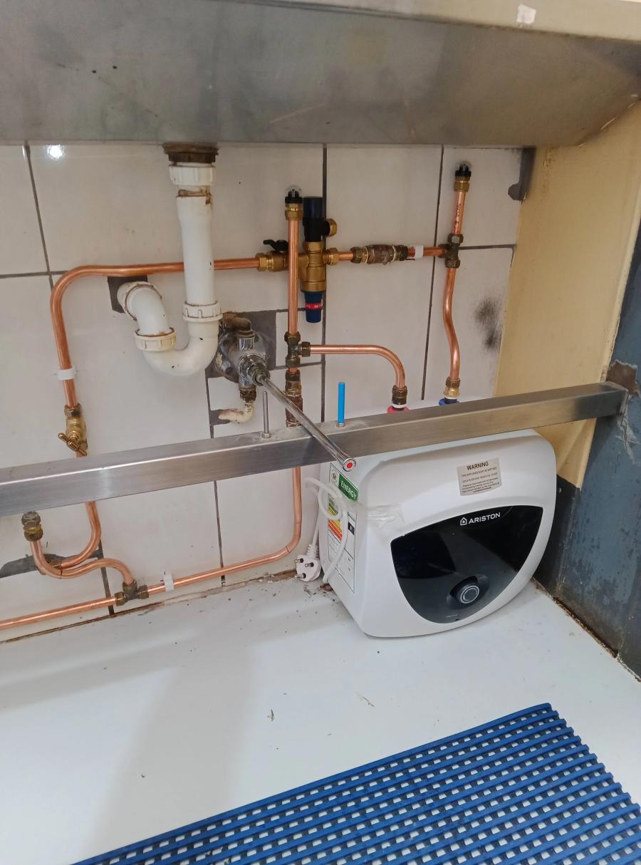 Compact water heater installed with copper pipework